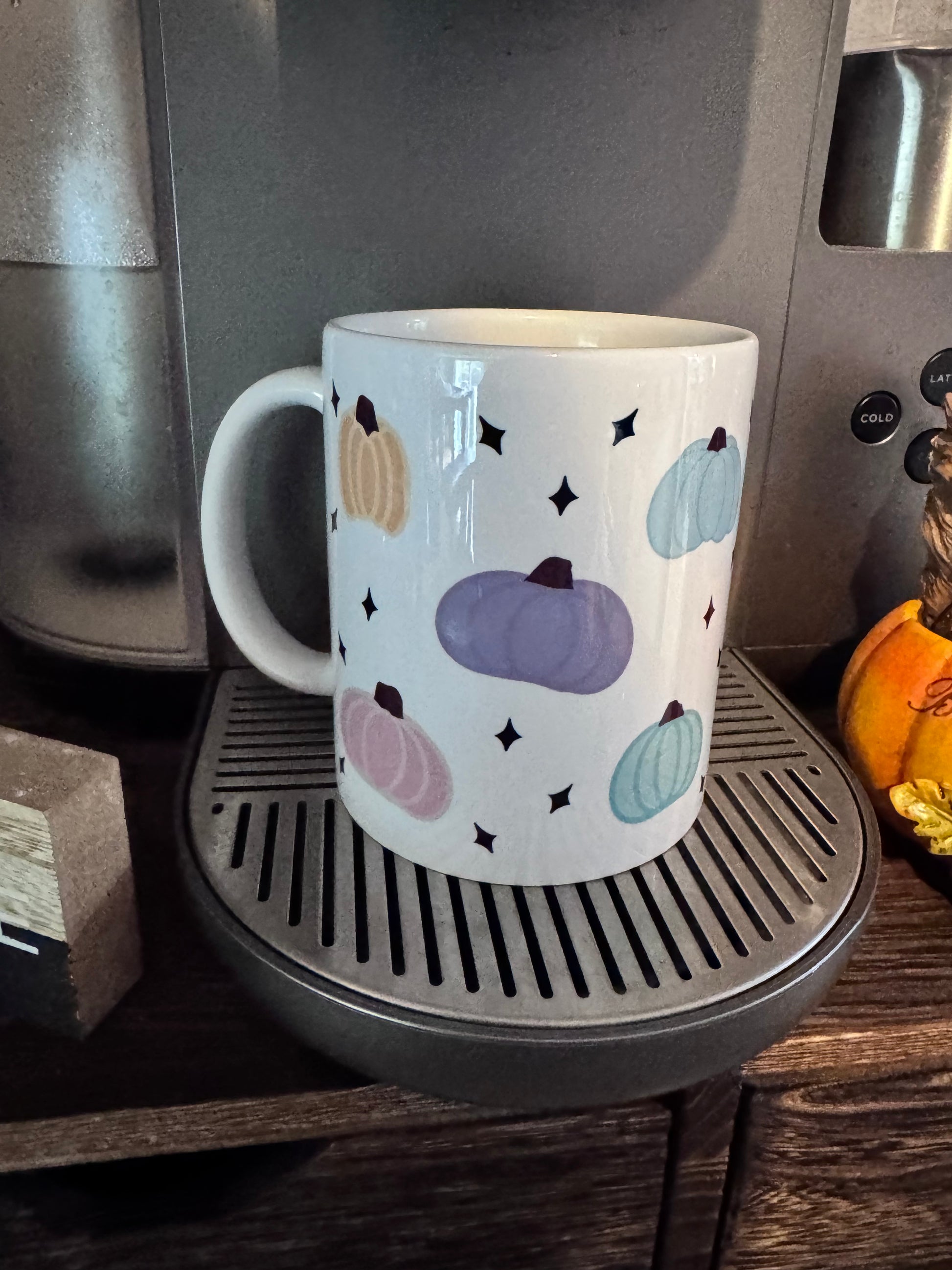 Close up of pastel pumpkin artwork on glossy ceramic mug