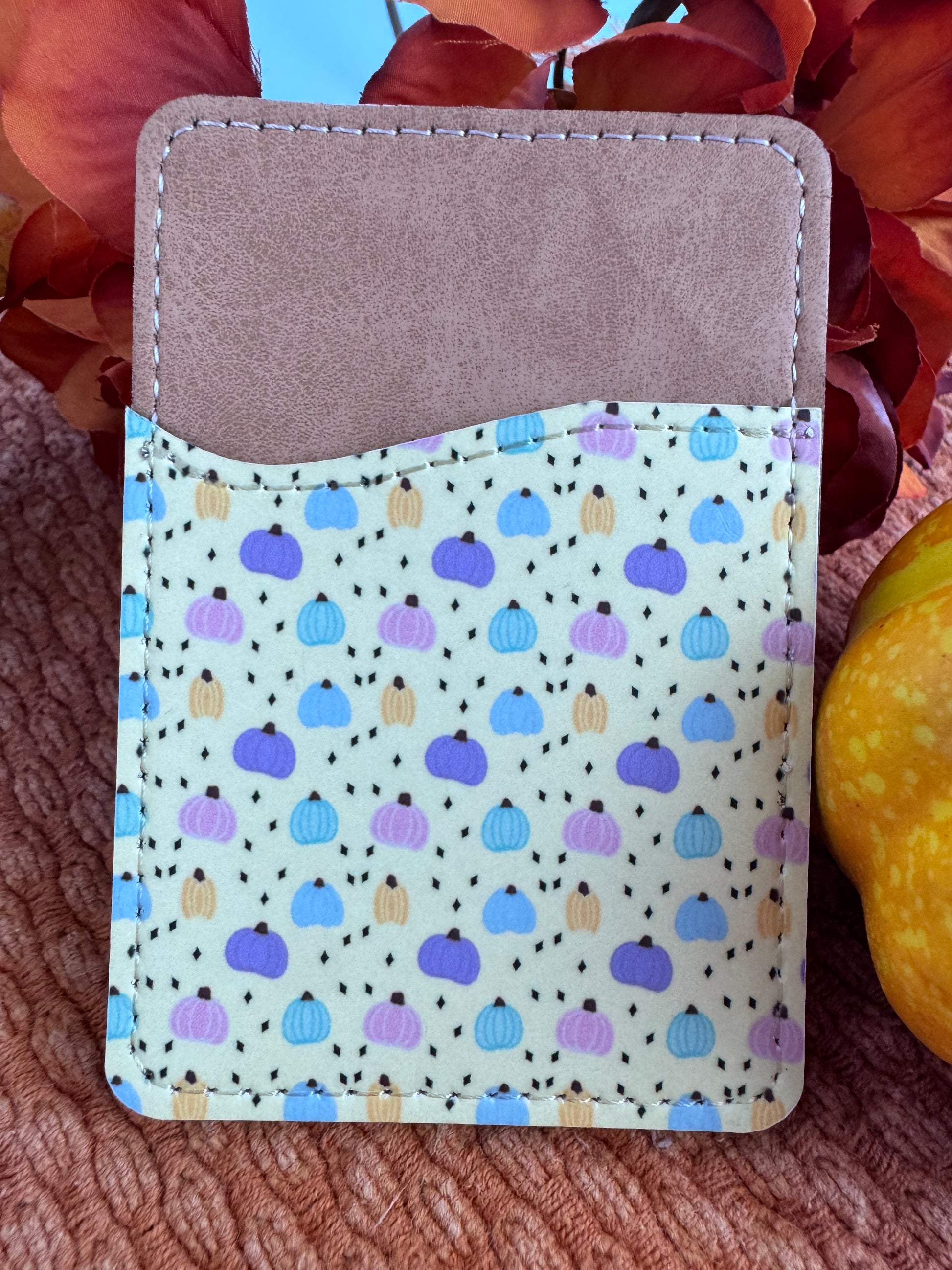 Pastel pumpkin sublimated faux leather phone wallet on yellow beige background